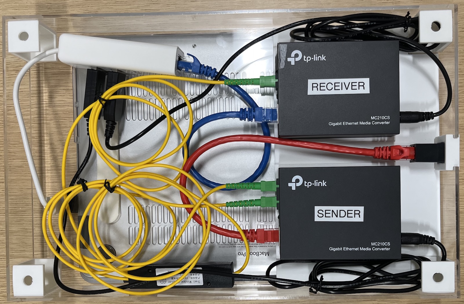 The internals of the data diode enclosure. The data diodes are powered by a USB Ethernet adapter, which also connects the receiver data diode to the laptop.